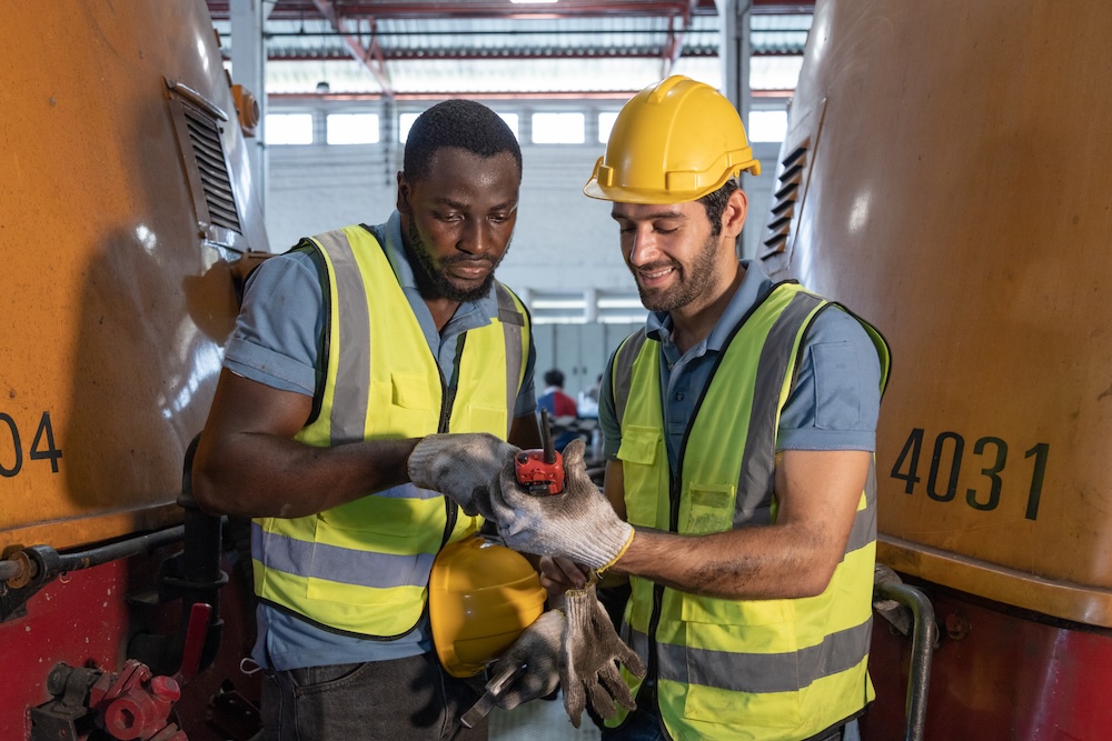 Portrait d'un train de mécanicien Inspectez le moteur diesel du train, la voie ferrée dans le dépôt du train