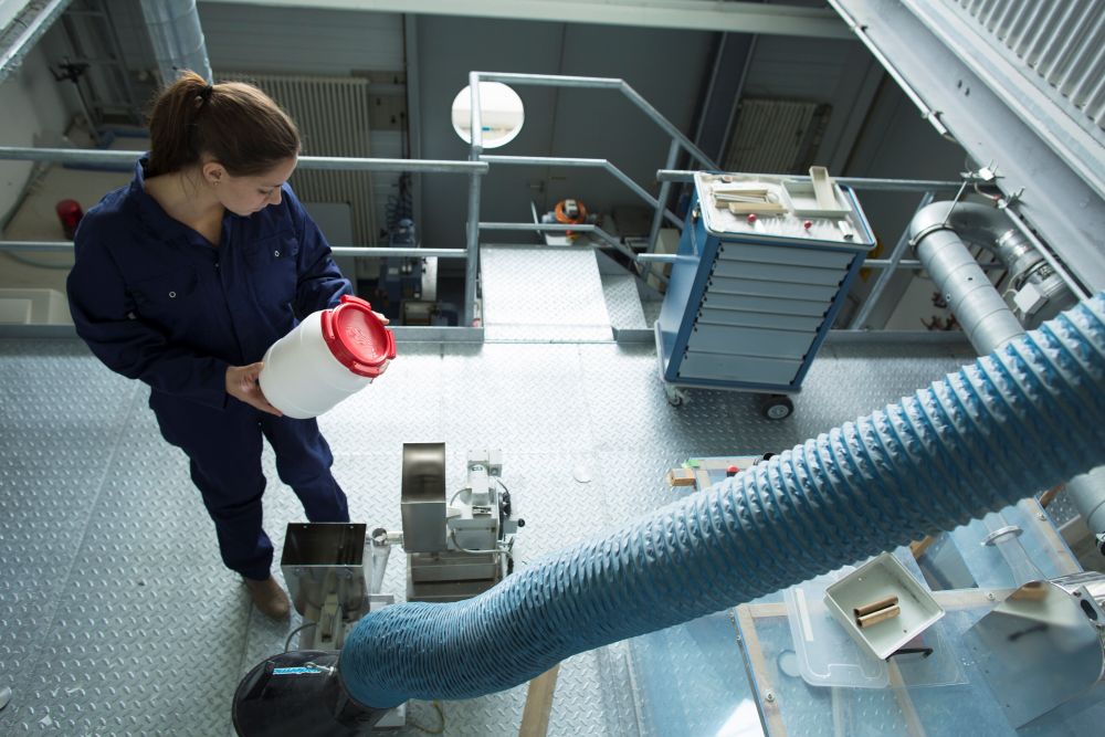 high-angle-view-of-factory-worker-reading-instruct